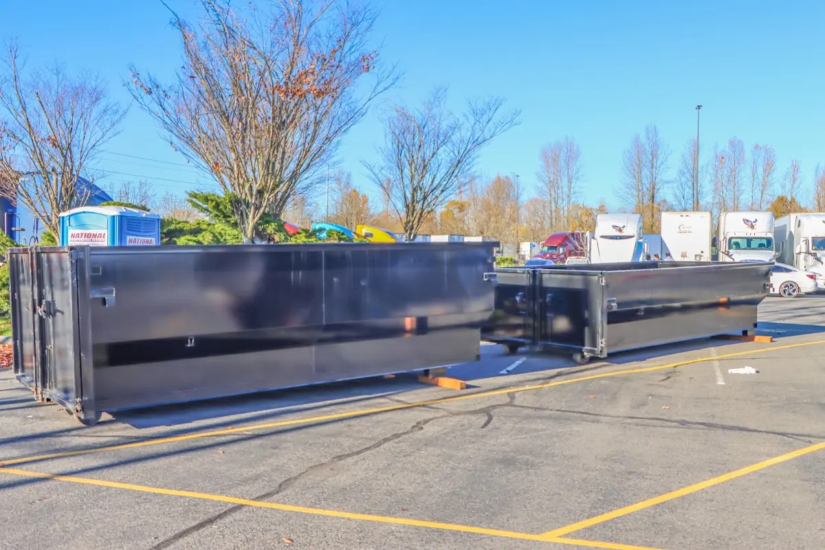 Professional dumpster rental service with roll-off container on residential driveway in Cerritos